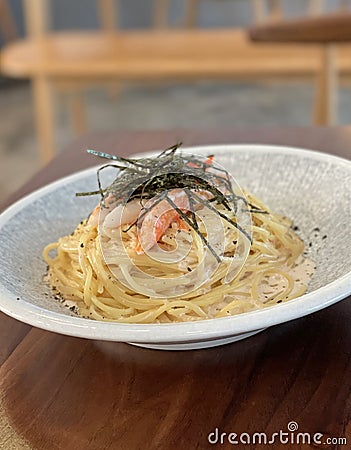 Classic Italian food creamy spaghetti with crab willow and seaweed in the restaurant Stock Photo