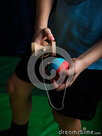 Classic Japanese game kendama, boy hands playing kendama Stock Photo