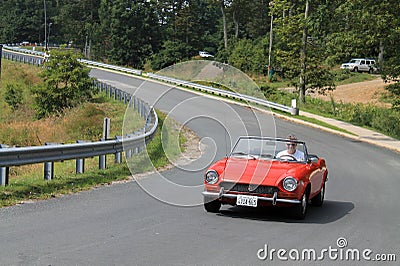 Classic little red italian sports car on downhill road Editorial Stock Photo