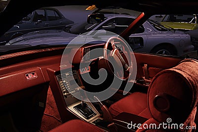 Classic Mazda car interior with red velours and leather and sports Mazda RX-7 in the retro garage Editorial Stock Photo