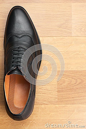 Classic mens shoes stand on the wooden floor Stock Photo