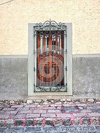 Classic mexican street san miguel de allende long window with traditional metal structure and stone road street Stock Photo