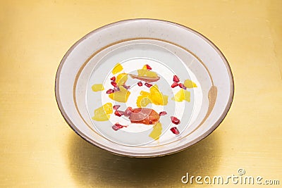 Classic milk dessert with a bit of innovation by adding some pieces of mango and grains of pomegranate Stock Photo