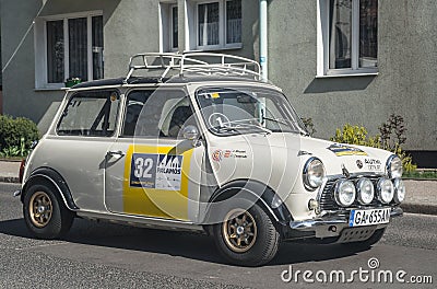 Classic old vintage small car white Morris Mini Cooper driving Editorial Stock Photo