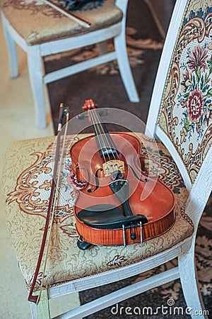 Classic music violin vintage, close up. Violin on chair Stock Photo