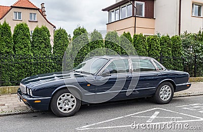 Classic old dark blue Jaguar sedan left side view Editorial Stock Photo