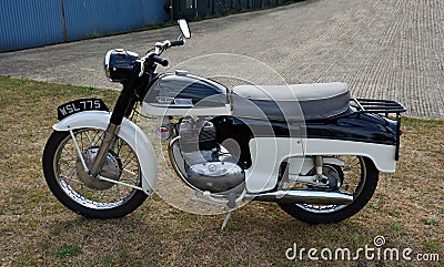 Classic Norton motorcycle parked on grass. Editorial Stock Photo