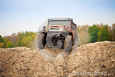 Classic off road car moving on dirt terrain Stock Photo