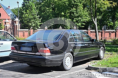 Classic old black sedan car Mercedes Benz S320 rear and right side view parked Editorial Stock Photo