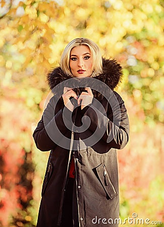 Classic parka coat has become wardrobe icon. Versatile functional and stylish. Girl wear parka while walk park. Autumn Stock Photo