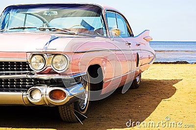 Classic pink Cadillac at beach Stock Photo