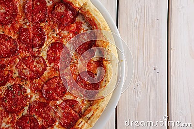 Classic pizza pepperoni on wooden background Stock Photo