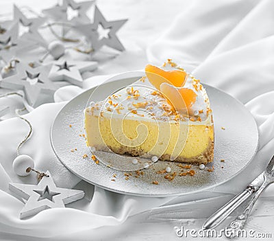 Classic Polish sernik cheesecake with tangerines on a white christmas concrete background. Copy space Stock Photo