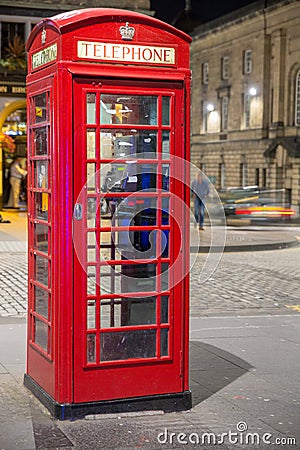 Classic red British telephone box, night scene Stock Photo