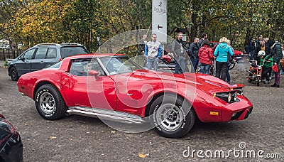 Classic red Chevrolet Corvette muscle car driving Editorial Stock Photo