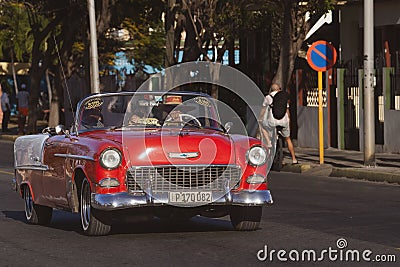 Classic red convertible automobile driving down a scenic route Editorial Stock Photo