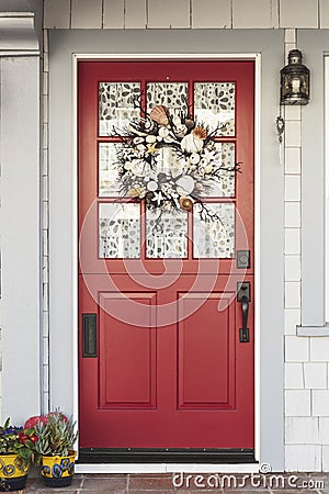 Classic red door to a white home Stock Photo