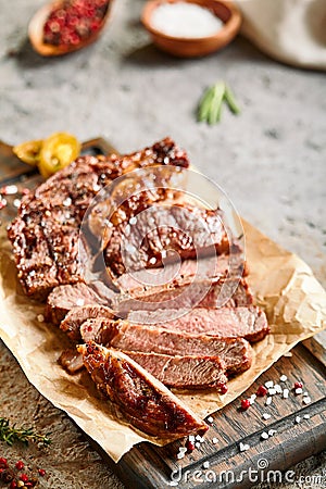 Classic ribeye steak served in waxed paper on wooden cutting board Stock Photo