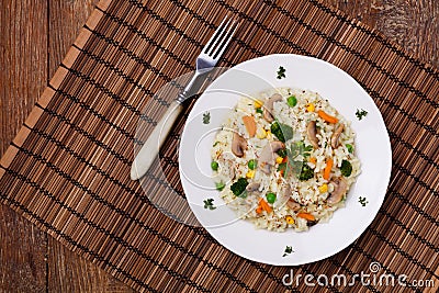 Classic Risotto with mushrooms and vegetables served on a white plate Stock Photo