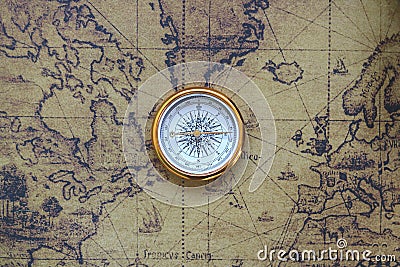 Classic round compass on background of old vintage map of world Stock Photo