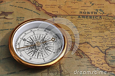 Classic round compass on old vintage map depicting North America and the United States of America Stock Photo