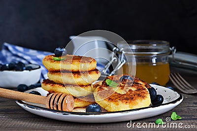 Classic Russian breakfast - cheesecake with honey Stock Photo