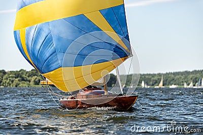 Classic sailing yacht with spinnaker on a lake in a regatta Stock Photo