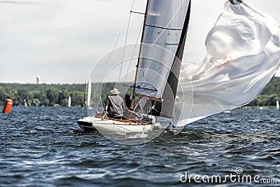 Classic sailing yacht with spinnaker on a lake in a regatta Editorial Stock Photo