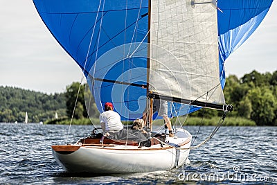 Classic sailing yacht with spinnaker on a lake in a regatta Editorial Stock Photo