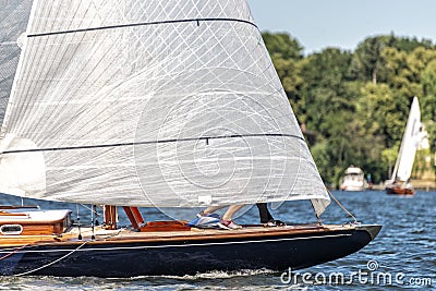 Classic sailing yacht with spinnaker on a lake in a regatta Stock Photo