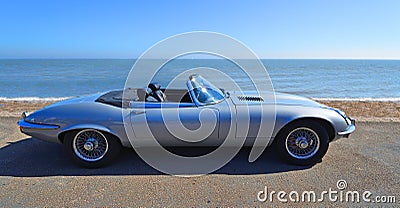 Classic Silver Jaguar E Type convertible Motor Car Parked on Seafront Promenade. Editorial Stock Photo