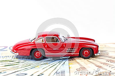 A classic sports car of the year 1954 of red color over euro bills Stock Photo