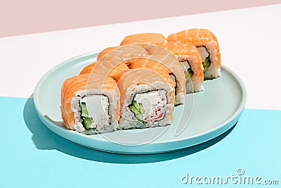 Classic sushi roll with salmon outside, crab, cheese and cucumber inside. Philadelphia maki in minimal style. Modern japanese menu Stock Photo
