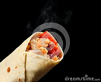 Classic tortilla wrap roll with grilled crispy chicken or turkey and vegetables, tomato, paprika pepper with steam smoke Stock Photo