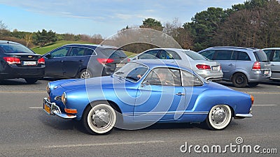 Classic vintage antique blue VW Karmann Ghia coupe driving Editorial Stock Photo