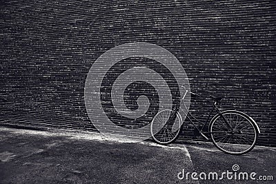 Classic vintage hipster bicycle leaning against the street wall Stock Photo