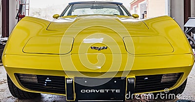 Yellow Vintage Corvette in Garage Editorial Stock Photo