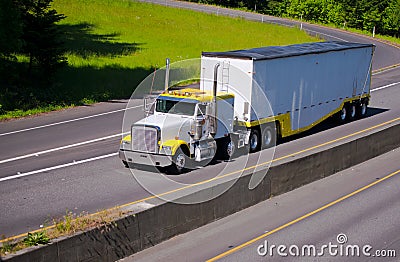 Classic working heavy semi truck with bulk trailer on highway ne Stock Photo