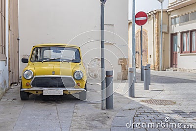 A classic yellow mini cooper parked Editorial Stock Photo