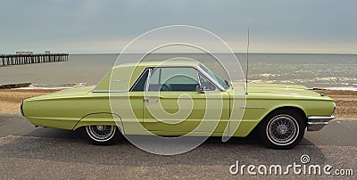 Classic Yellow Thunderbird motor car parked on seafront promenade. Editorial Stock Photo