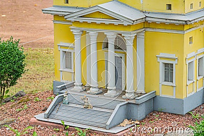 A classical building with a symmetrical facade, likely Doric columns, two doorways, and a pediment The structure is made Editorial Stock Photo