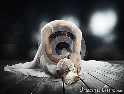 Classical dancer stretching on a stage of theater Stock Photo