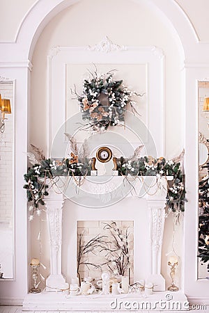 Classical fireplace decorated with tree branches. Vertical Stock Photo