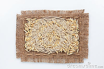 Classical frame made of burlap with grains of oats Stock Photo