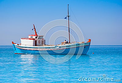 Classical Greek fishing boat in the sea Stock Photo