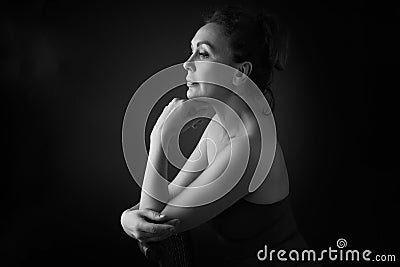 Portrait of a sensual fifty year old woman on grey studio background. Monochrome shot. Stock Photo