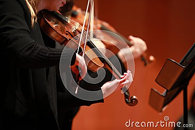 Classical music. Violinists in concert. Stringed, violinist.Closeup of musician playing the violin during a symphony Editorial Stock Photo