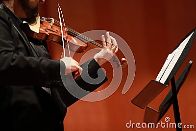 Classical music. Violinists in concert. Stringed, violinist.Closeup of musician playing the violin during a symphony Editorial Stock Photo