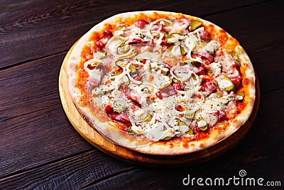 Classical napoli pizza with salami and gherkins Stock Photo