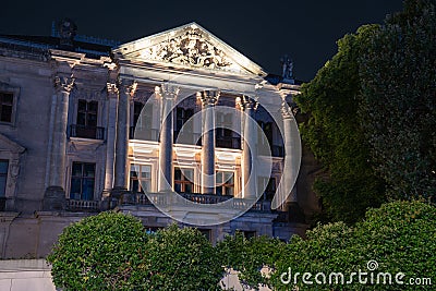 Classical ornate building facade with ornate pediment above six pillars Stock Photo